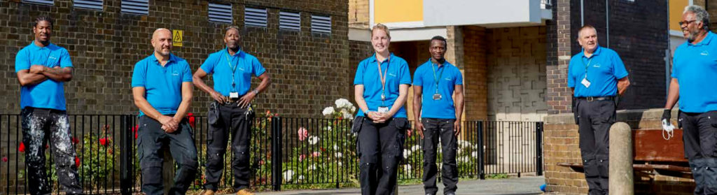 Housing staff standing outside an estate