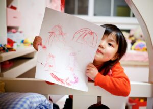 Child holding a drawing 