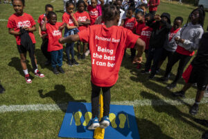 Children taking part in Personal Bests activity in a sports field