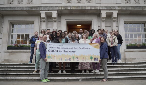 Staff from Hackney Children and Family Services holding their Ofsted rating banner